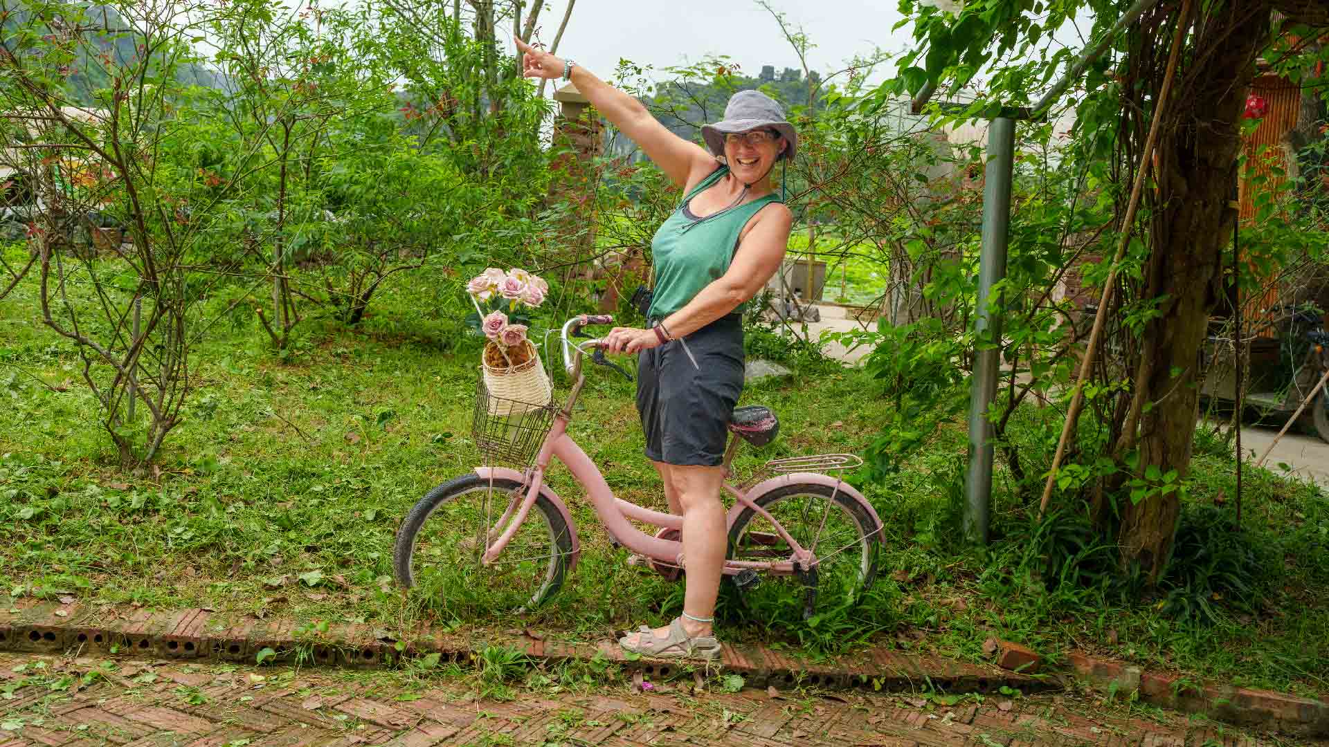 María's Green Adventure - Embracing Sustainable Travel on a Pink Bicycle María riding a pink bicycle surrounded by greenery, promoting sustainable travel and eco-friendly adventures