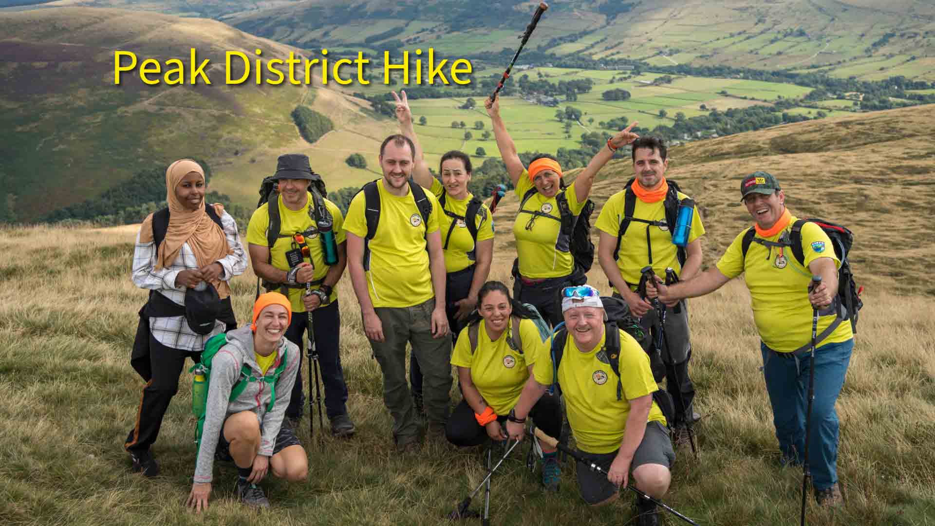 Peak District hike with Hiking in London Club Group of hikers from Hiking in London Club smiling on a trail in the Peak District