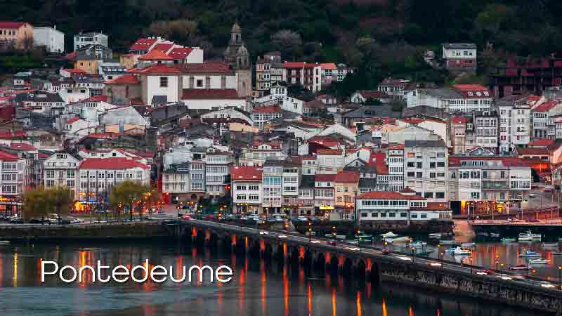 Pontedeume, Galicia – A scenic medieval town on the English Way of the Camino de Santiago A panoramic view of Pontedeume, Galicia, showing the historic bridge, colorful houses, and the Church of Santiago nestled among green hills