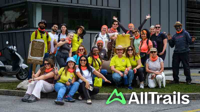 Group photo of Hiking in London Club members wearing orange bandanas and hiking gear
