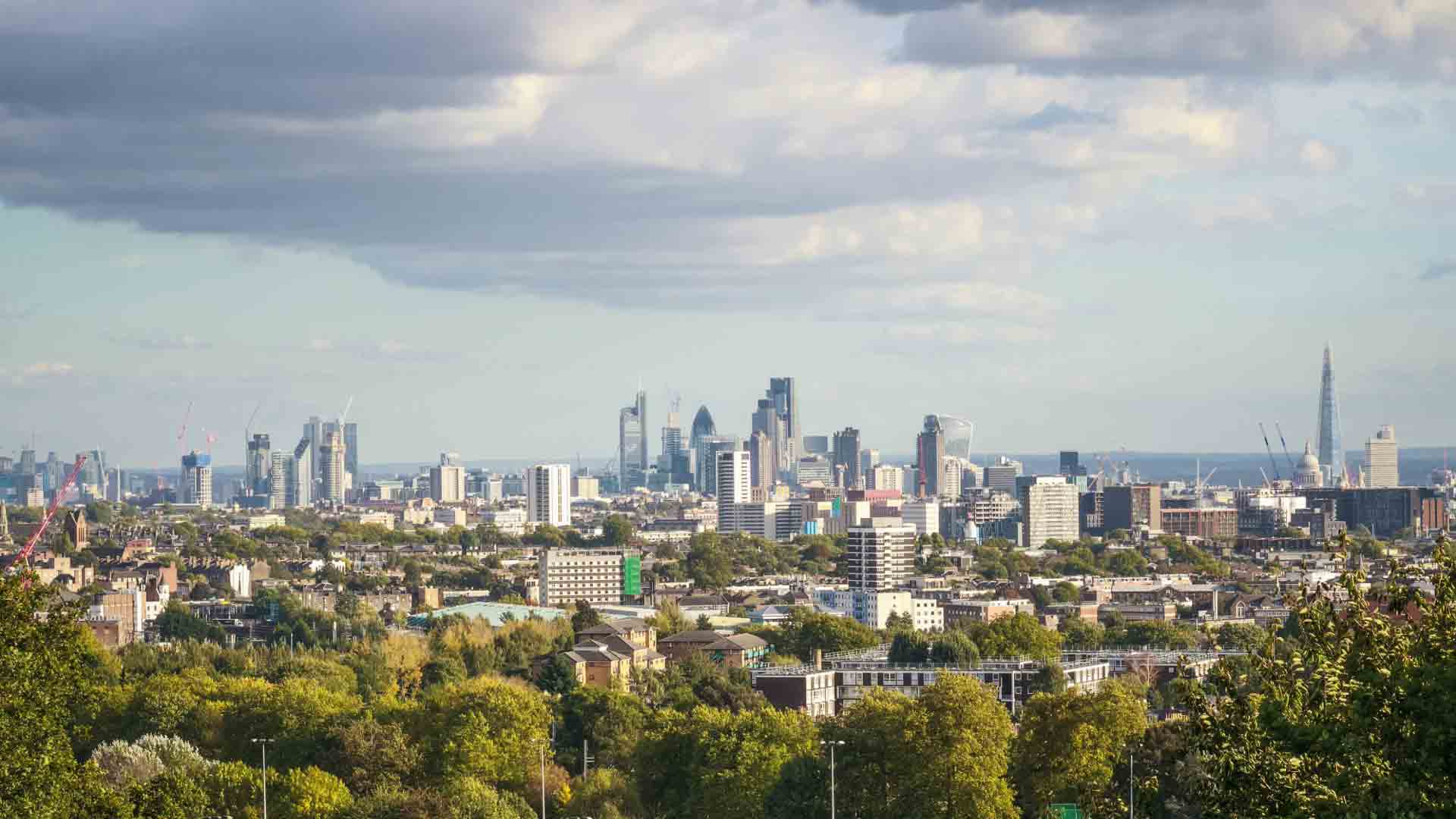 View from Parliament Hill overlooking the city of London Panoramic skyline of London viewed from Parliament Hill on a partly cloudy day.