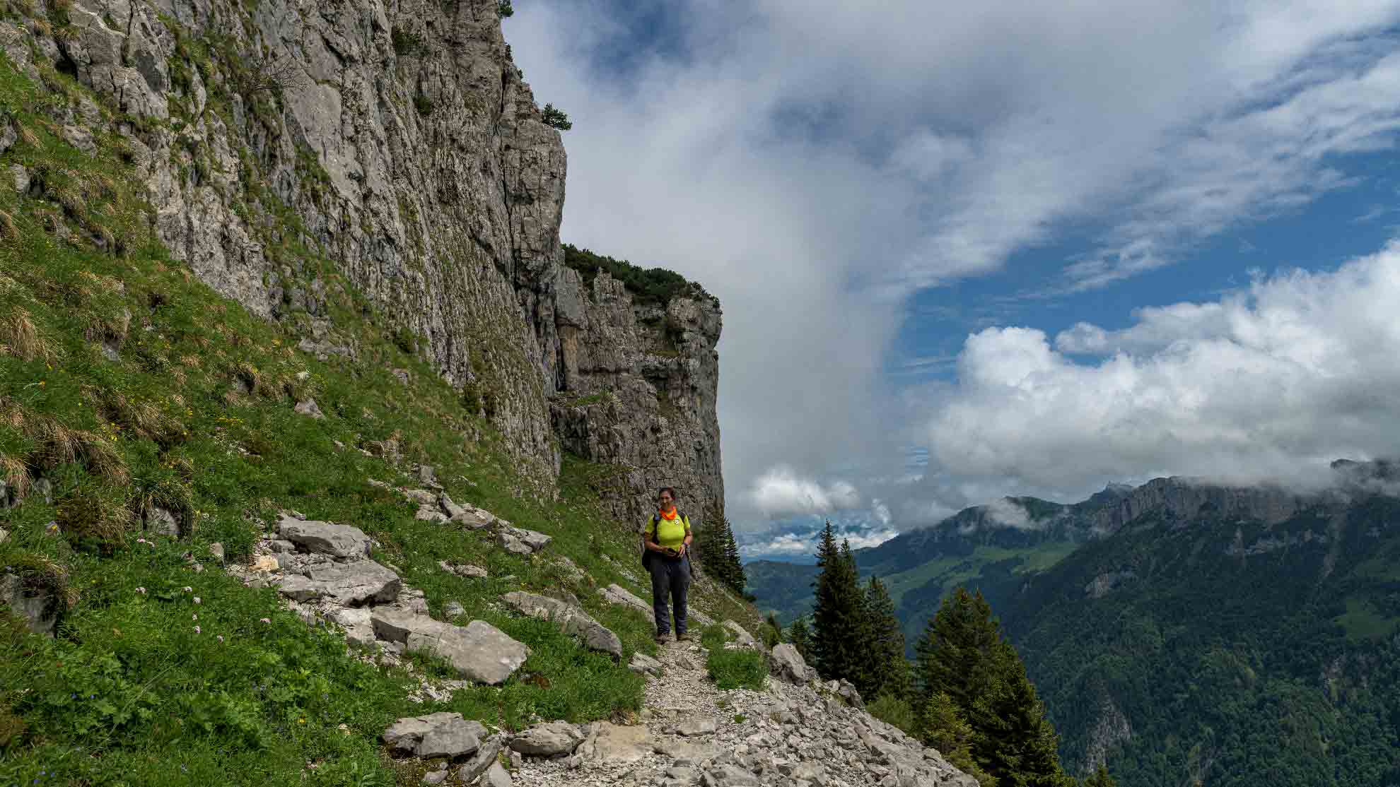 Hiking the Alpstein Trail near Seealpsee, Switzerland – Summer Weekend Adventure Hiker on the Alpstein Geological Trail with panoramic views of the Swiss Alps